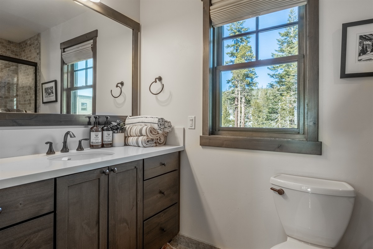 The main level bathroom features a tub/shower combo—easy and convenient for guests using the living area or bunkroom, and perfect for quick resets between adventures.