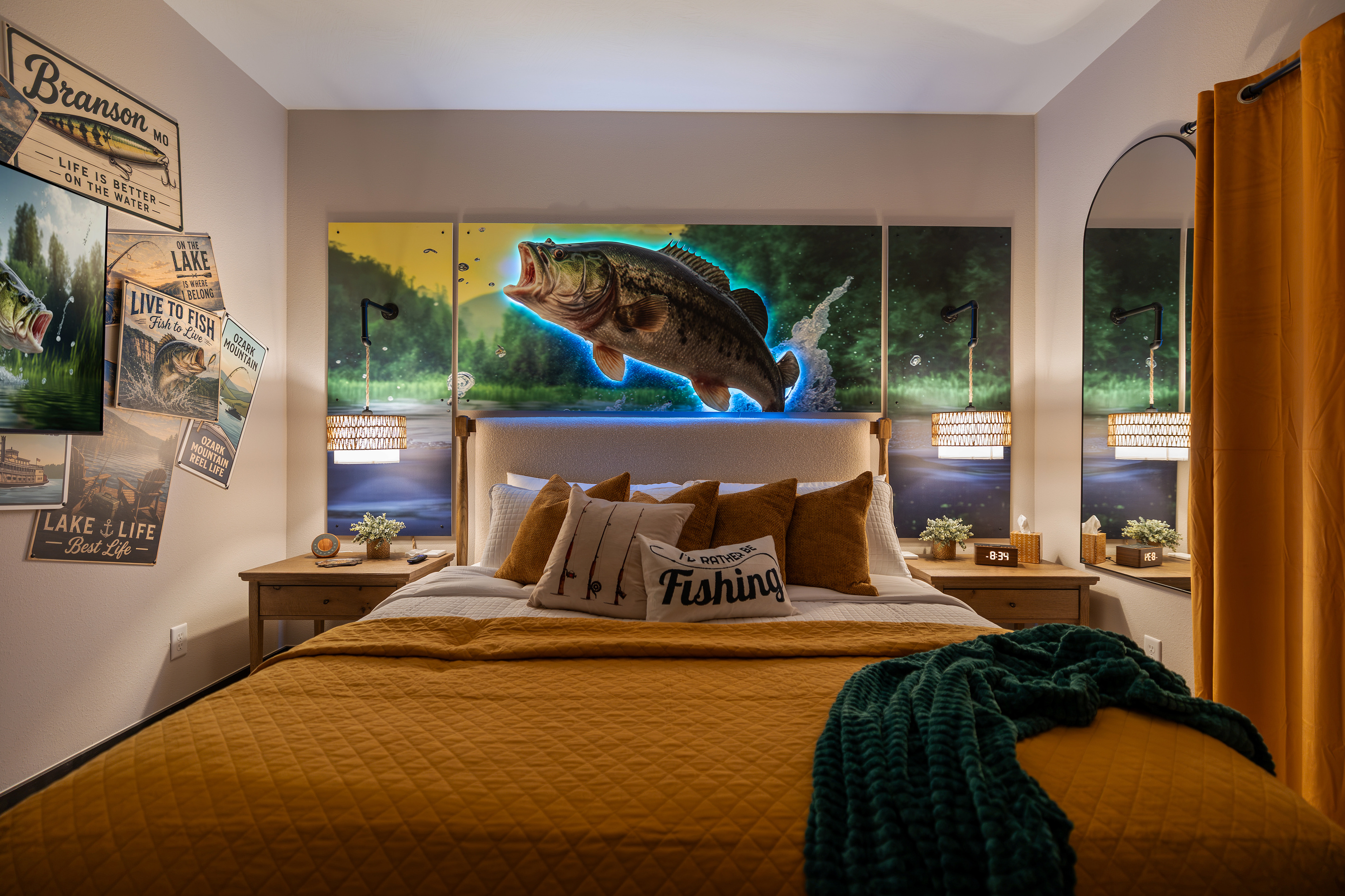 Warm lamps and vintage tackle art on either side of the bed.