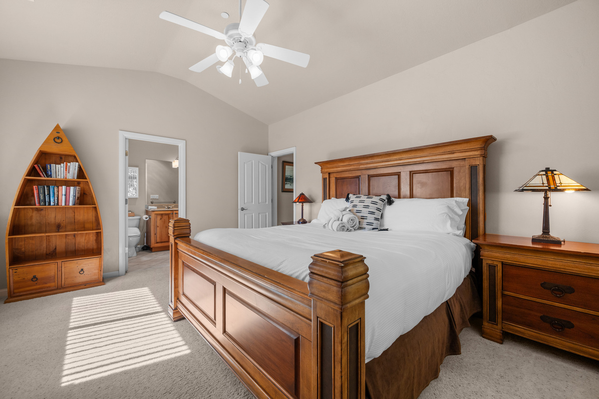 Inviting primary bedroom featuring warm wood furnishings and relaxing resort-style comfort.
