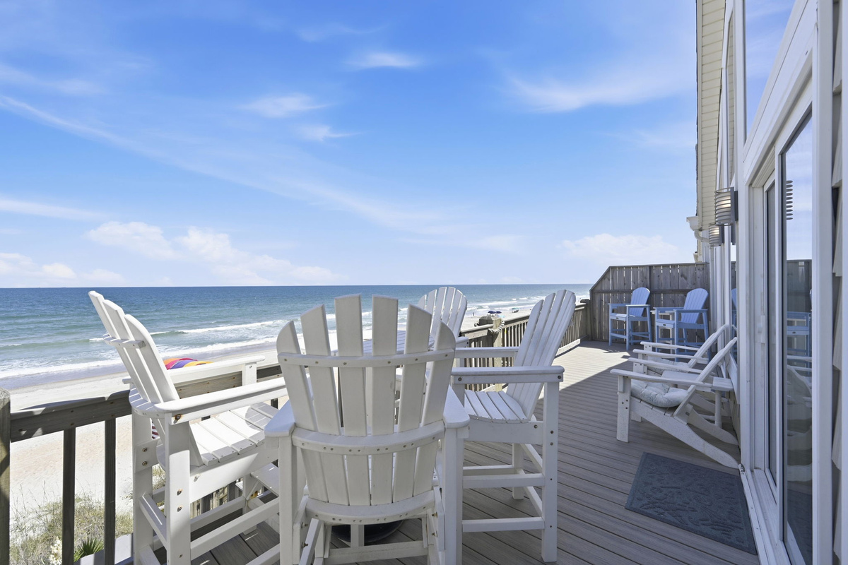 Oceanfront deck with Adirondack seating and panoramic beach views