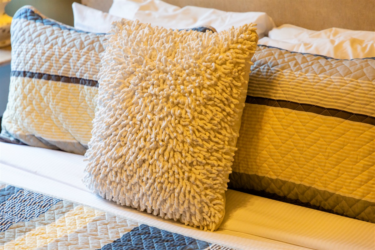 Soft textures and layered pillows create an inviting touch of comfort.