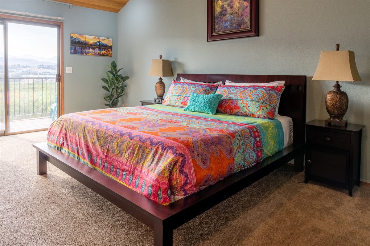 Primary suite with private balcony access and spectacular mountain, river, and valley views.