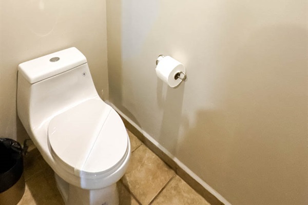 Private toilet area in spacious bathroom.