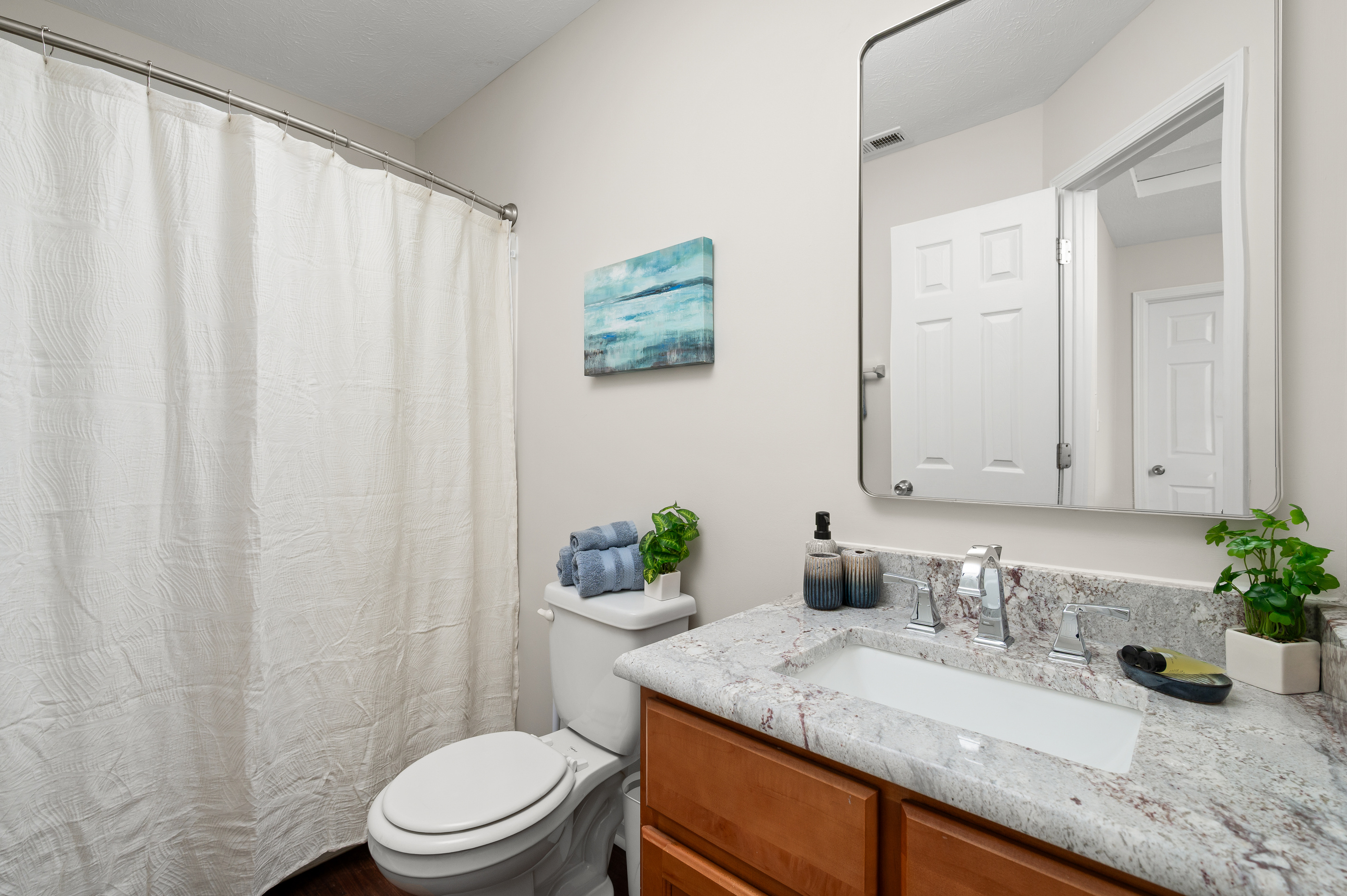 Enjoy the convenience of a private ensuite bathroom featuring a tub and shower combination, single vanity, and all the essentials you need to get ready for the day or unwind in the evening.