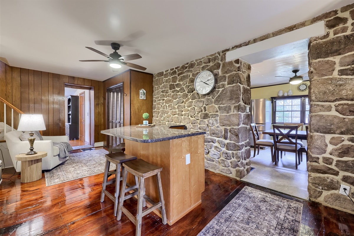 Island with 4 barstools and a comfy chair