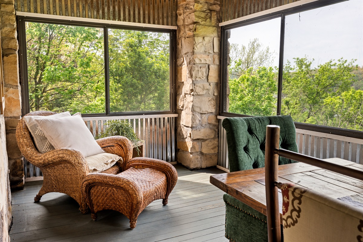 Cozy up with a book or morning coffee in this peaceful porch retreat.