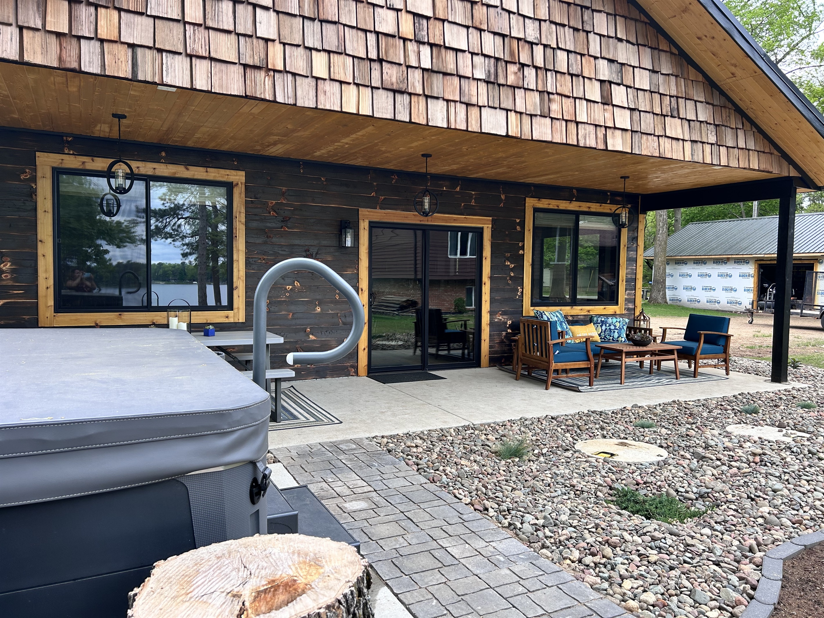Covered patio with picnic table, gas grill and seating area