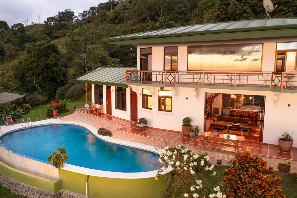 Daytime aerial view of Casa Infinity with infinity pool and tropical gardens