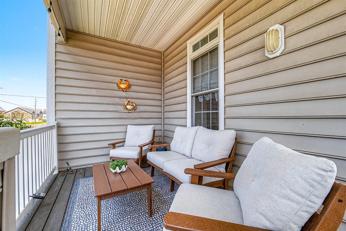 2nd porch seating area facing sunsets in the field