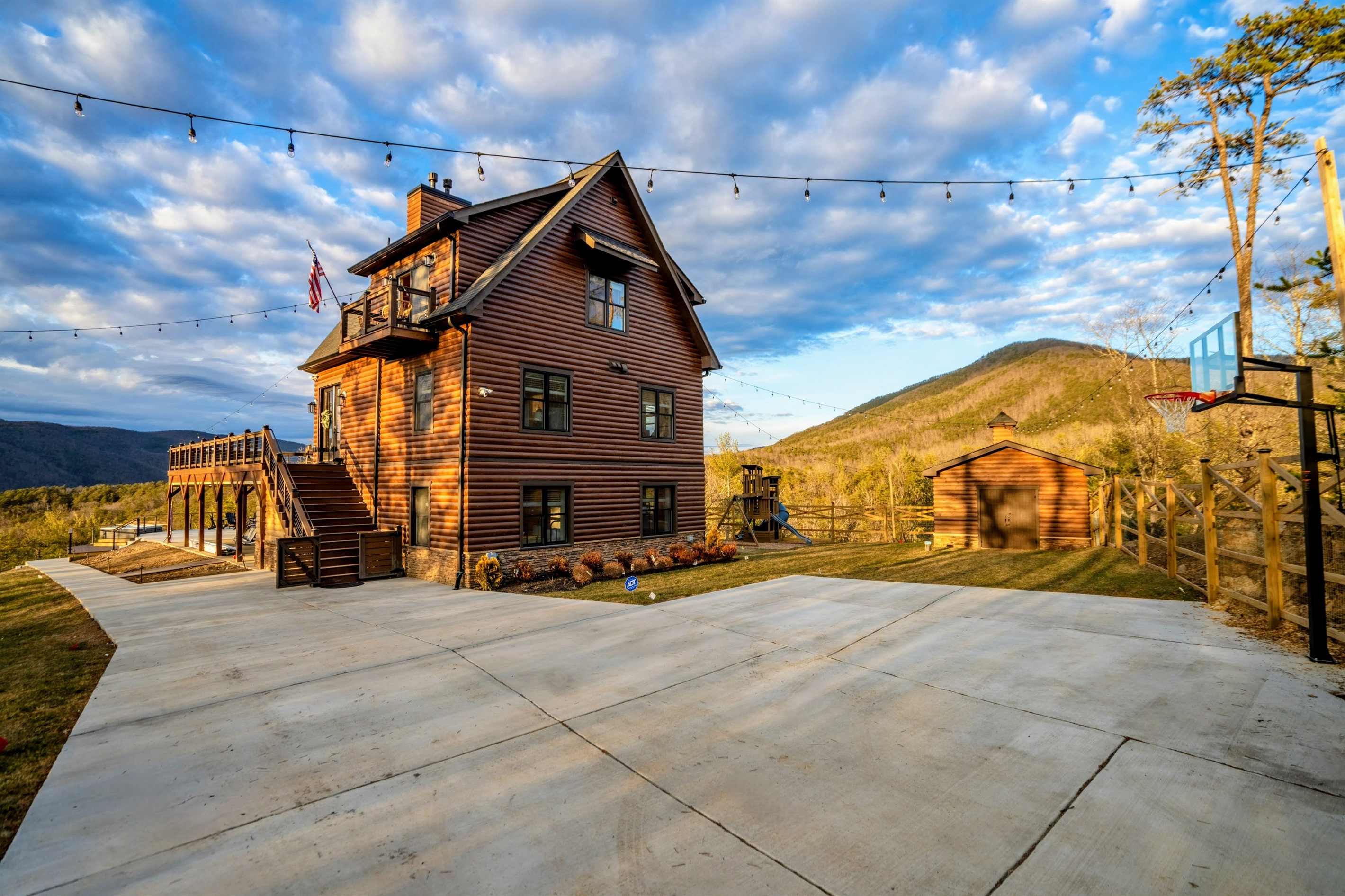 Golden Hour Welcome – Soaring peaks, warm wood tones, and open skies create a breathtaking arrival at this private summit retreat.