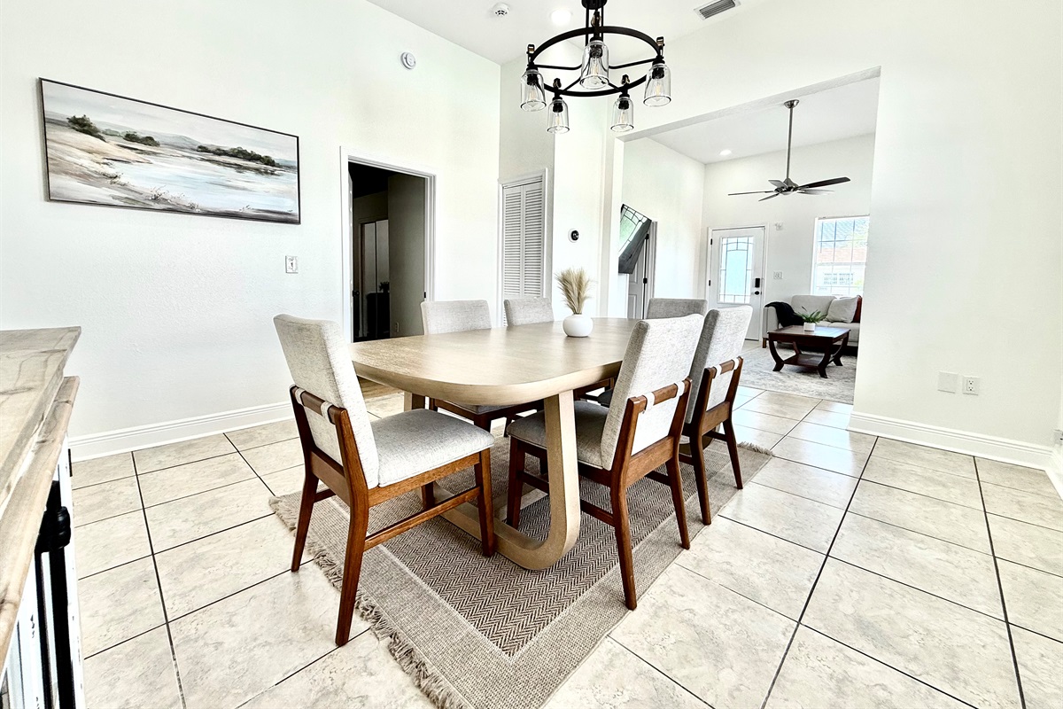 Minimalist art and modern farmhouse touches like the black chandelier add sophistication.