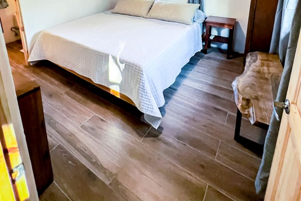 King Size bed with views of the garden.  Wifi connected smart TV on the wall facing the bed.