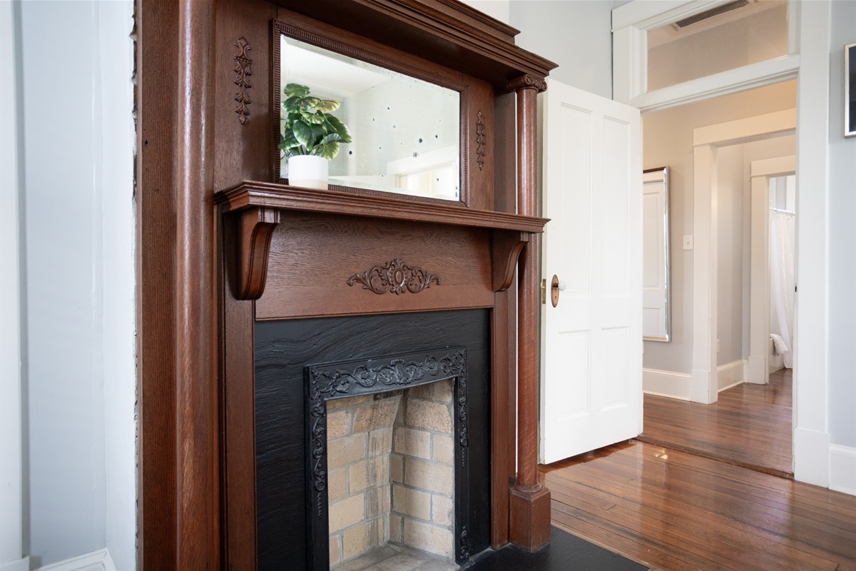 A decorative fireplace adds warmth and timeless elegance to the space.