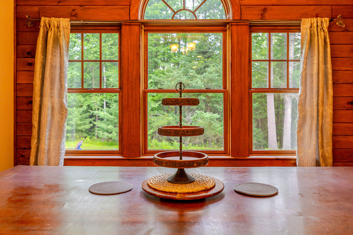 The dining area offers peaceful forest views, creating the perfect backdrop for family breakfasts, holiday dinners, and evening conversations.