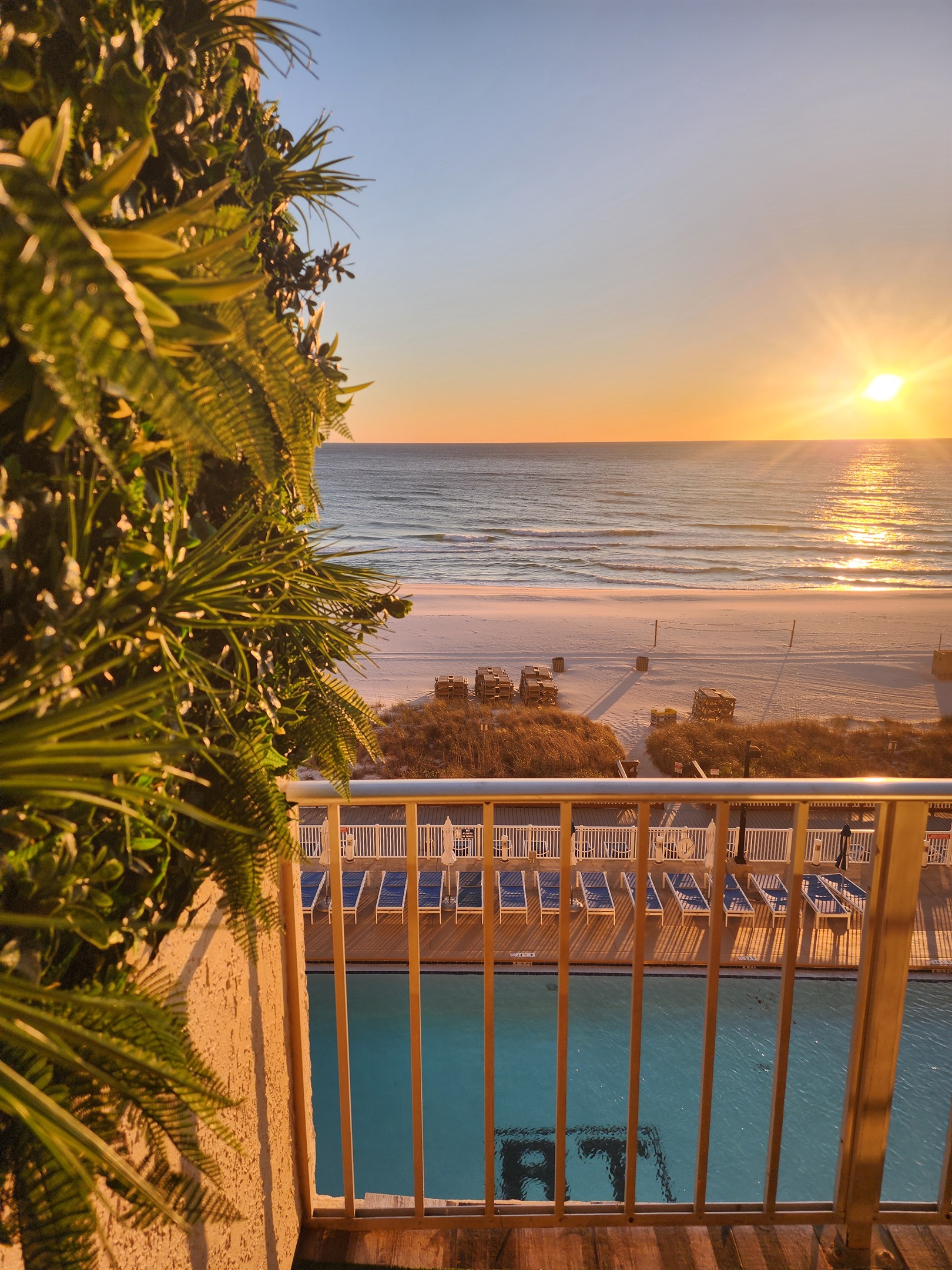 Stunning sunsets from your balcony with tropical decor for a Coastal Breeze vibe
