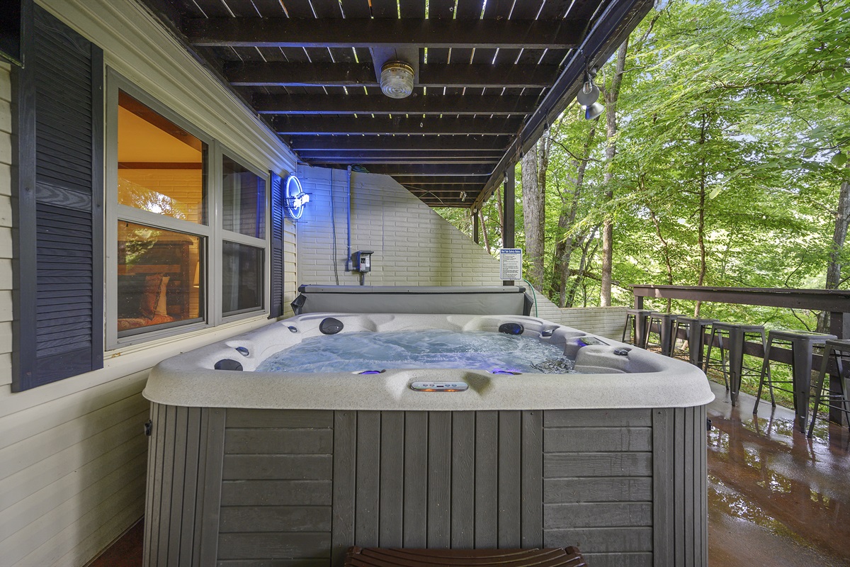 Relax in the hot tub with an outdoor TV.