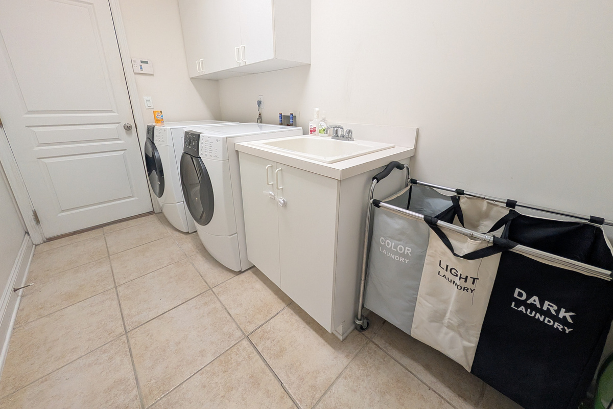 In-home laundry room with washer, dryer, utility sink, and plenty of space to keep longer stays convenient.