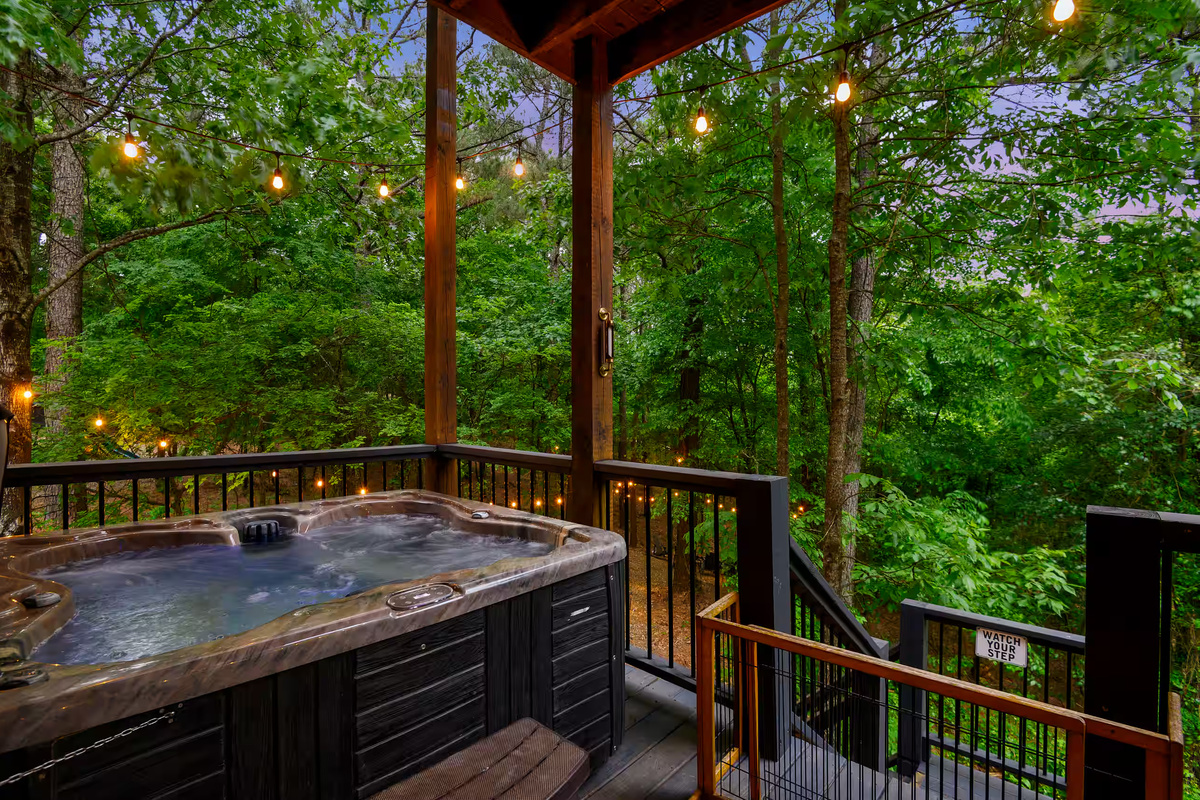 Hot Tub Retreat: Relax in the bubbling hot tub surrounded by nature and soft string lights!