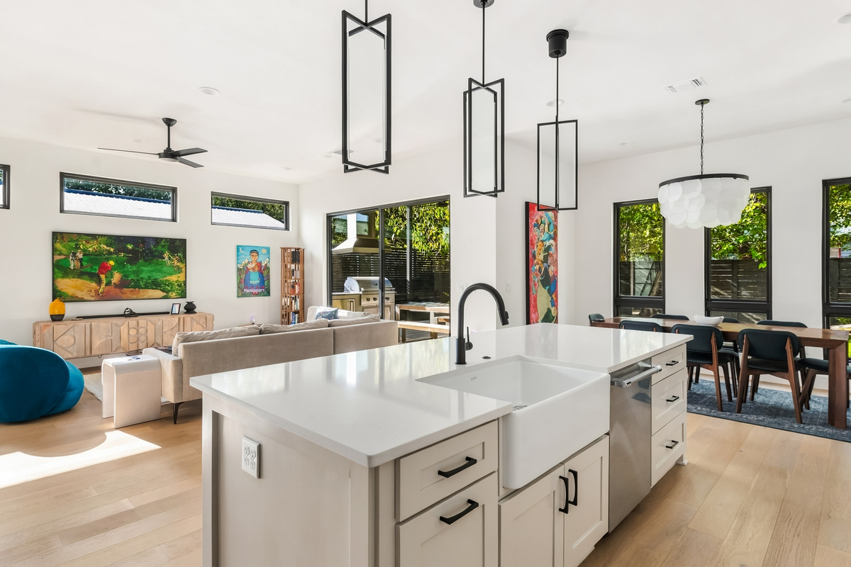 Farmhouse sink and oversized island make meal prep easy for the group.