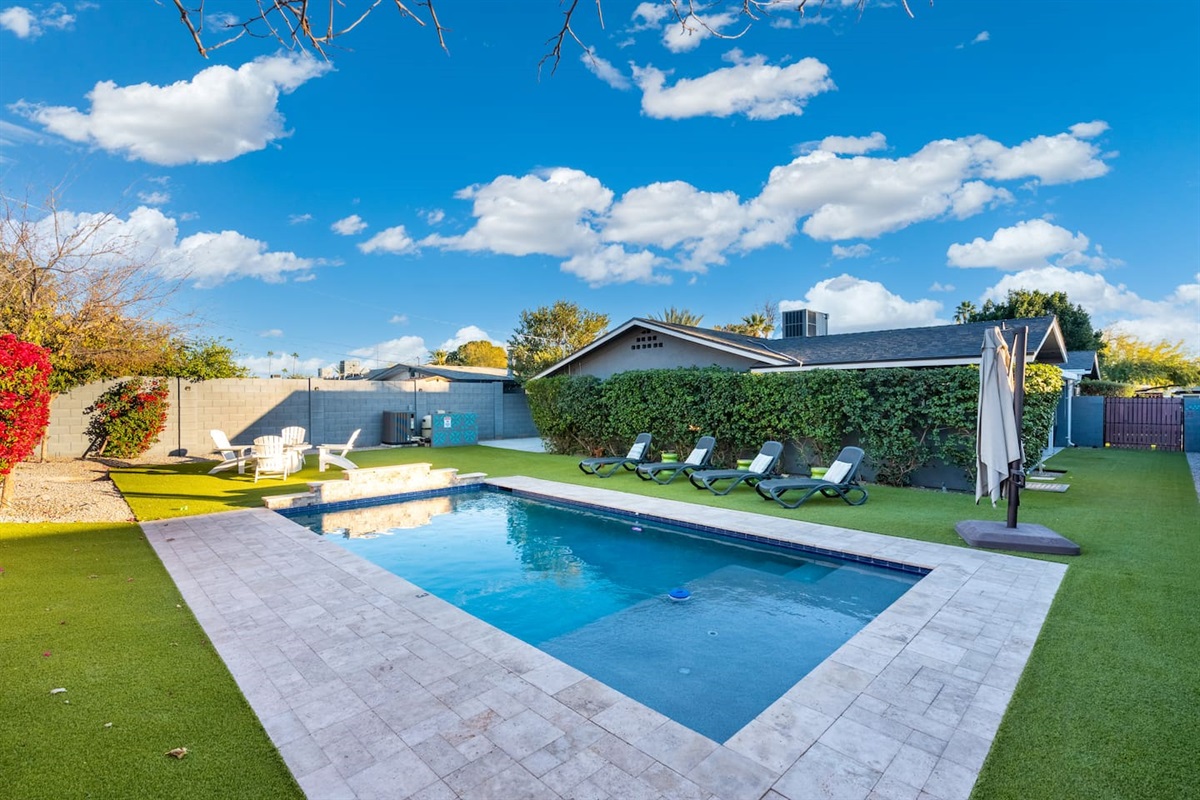 Crystal-clear pool view under bright daylight, with the sun reflecting off the water, creating a sparkling and refreshing scene.