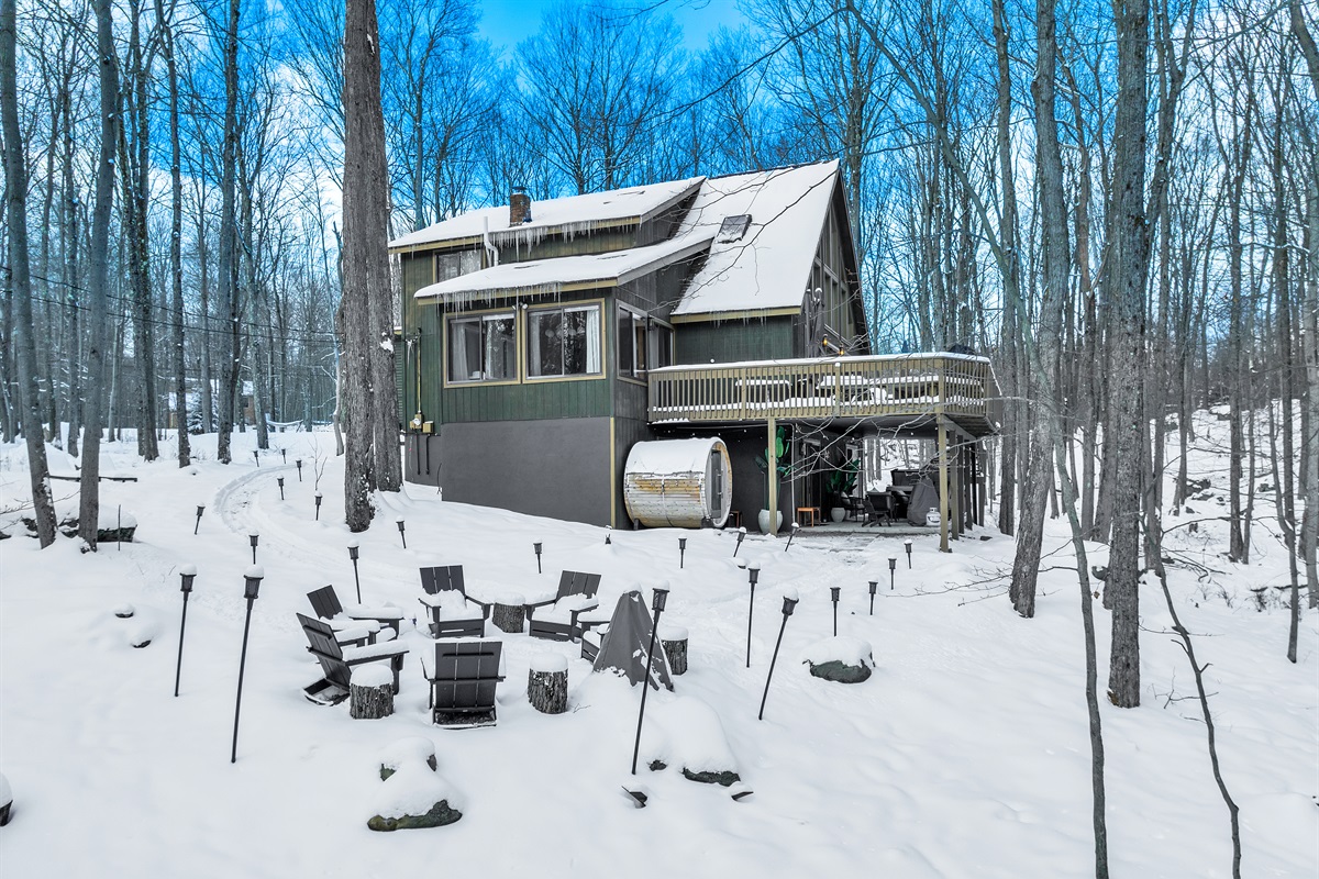 “Winter getaway perfection — firepit warmth and forest silence.”