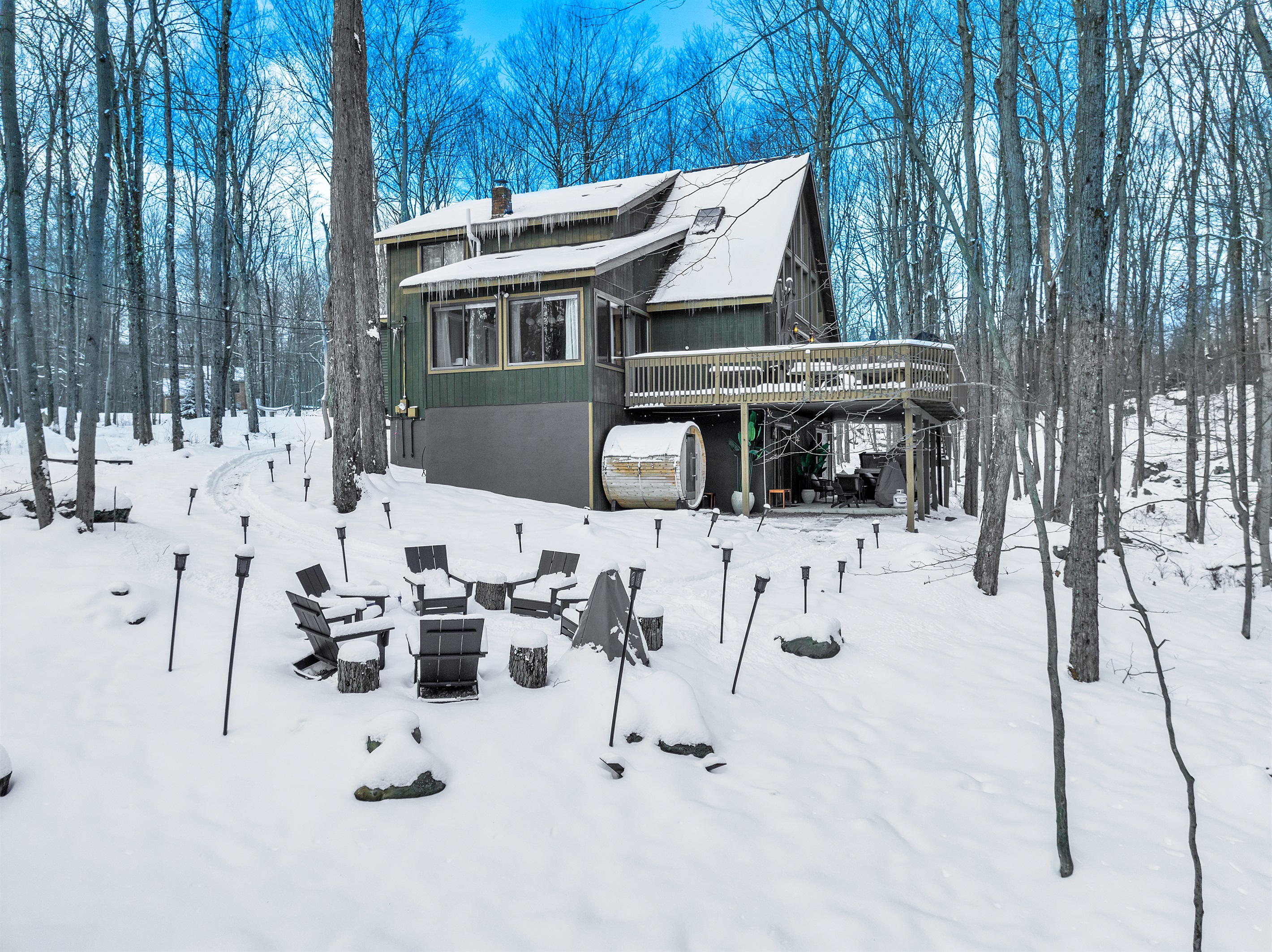 “Winter getaway perfection — firepit warmth and forest silence.”
