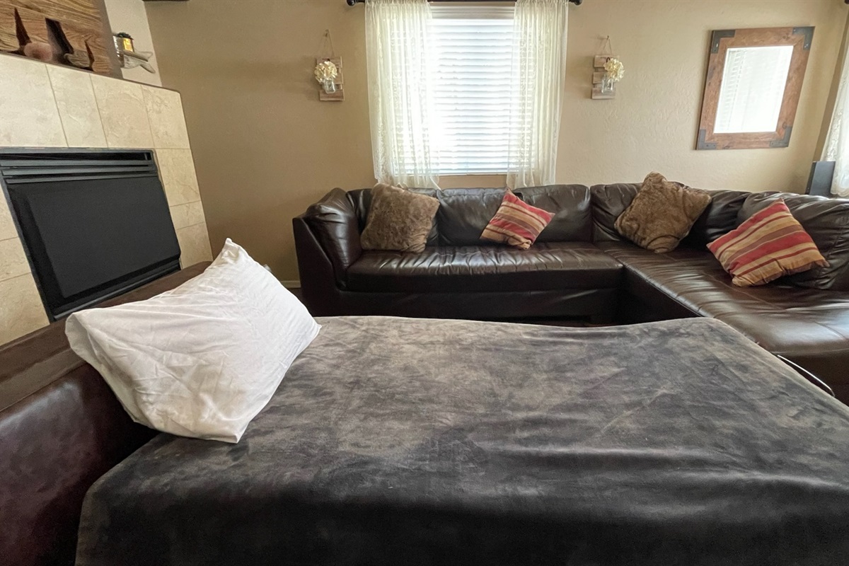 The ottoman converts into a convenient pull-out bed, providing flexible sleeping space for additional guests.