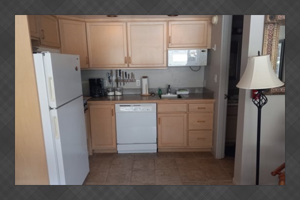 Kitchen area leading to bathroom.