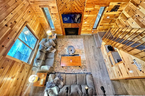 Two-story ceilings showcase the beautiful wood framing of this home.