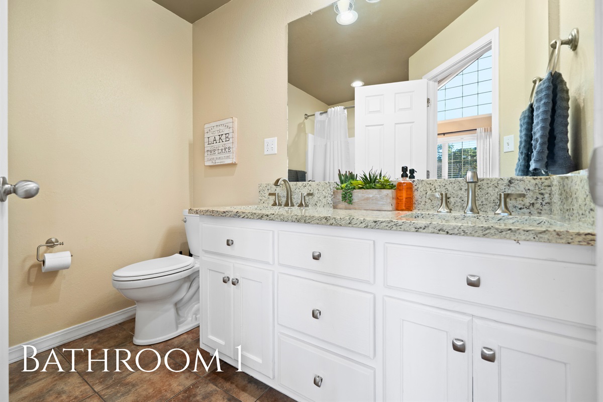 The bright and clean bathroom provides plenty of counter space and functionality to start or end your day comfortably.