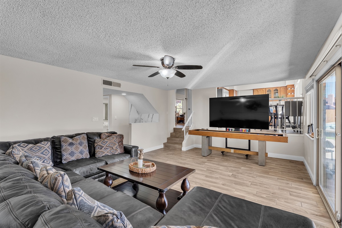 Living room 2 with 86 inch tv, shuffleboard, Nintendo switch, karaoke and bar sink