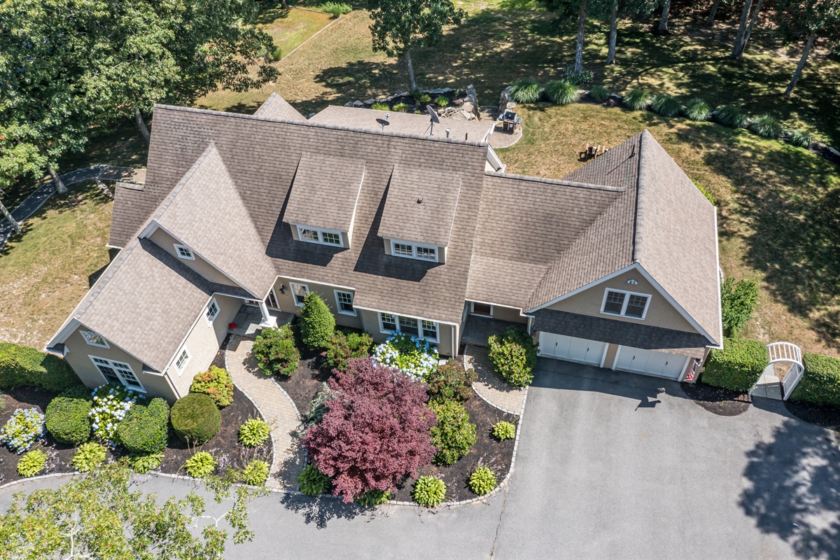 A full layout of lakeside living—grill, firepit, seating, and the water just steps away.