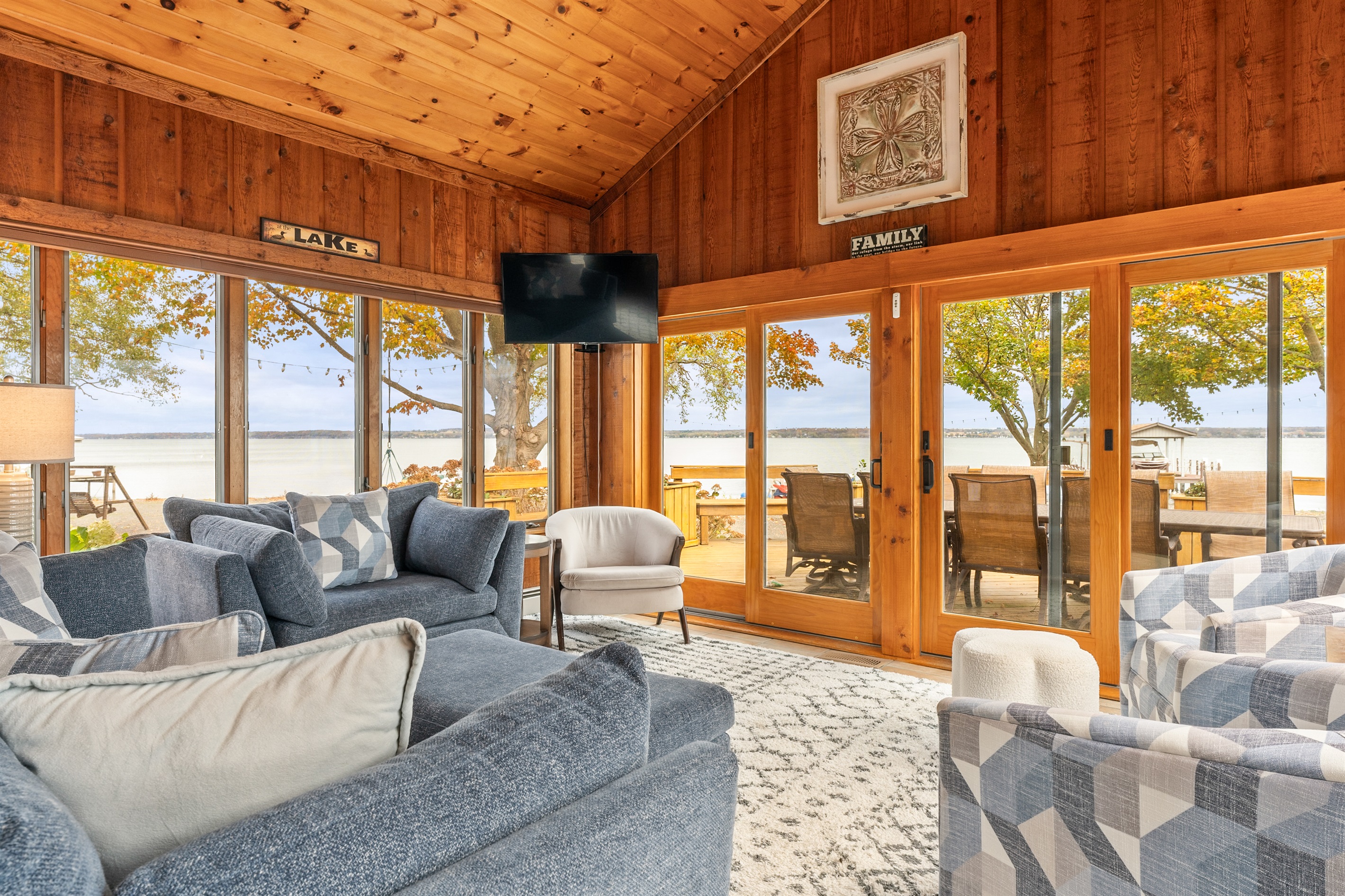Lakeside lounging at its finest! Enjoy panoramic water views from this cozy living room designed for comfort and connection