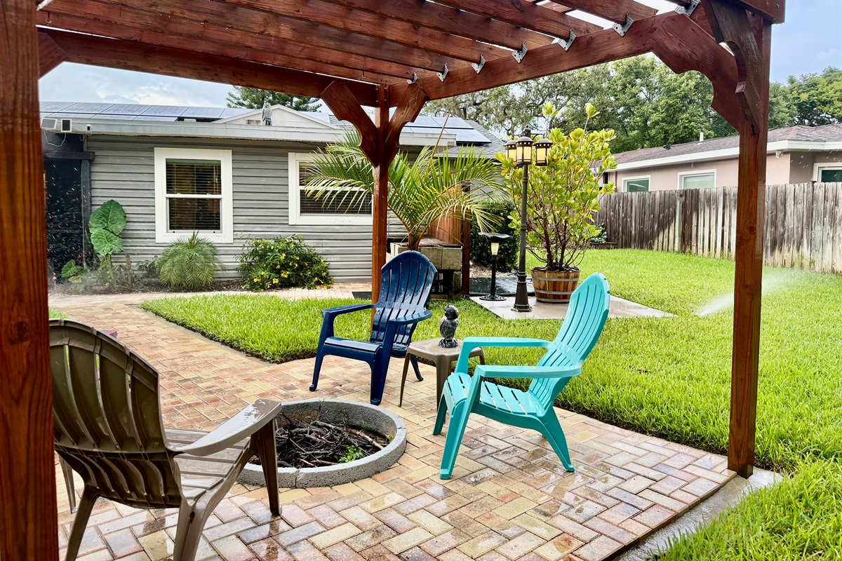 Gather around the fire pit beneath this charming wooden pergola—perfect for roasting marshmallows, sharing stories, or sipping wine under the stars.