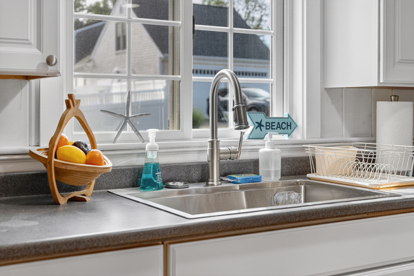 Double-basin sink with a sunny window view, making meal prep and cleanup easy and enjoyable.