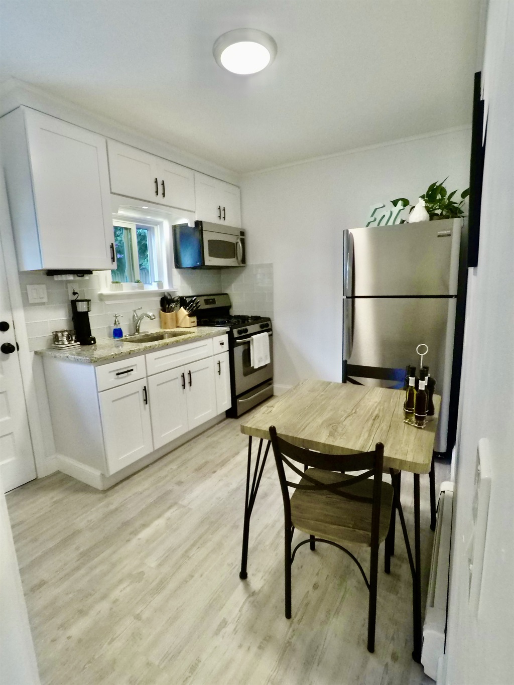 Newly renovated kitchen with granite countertop and stainless steel appliances