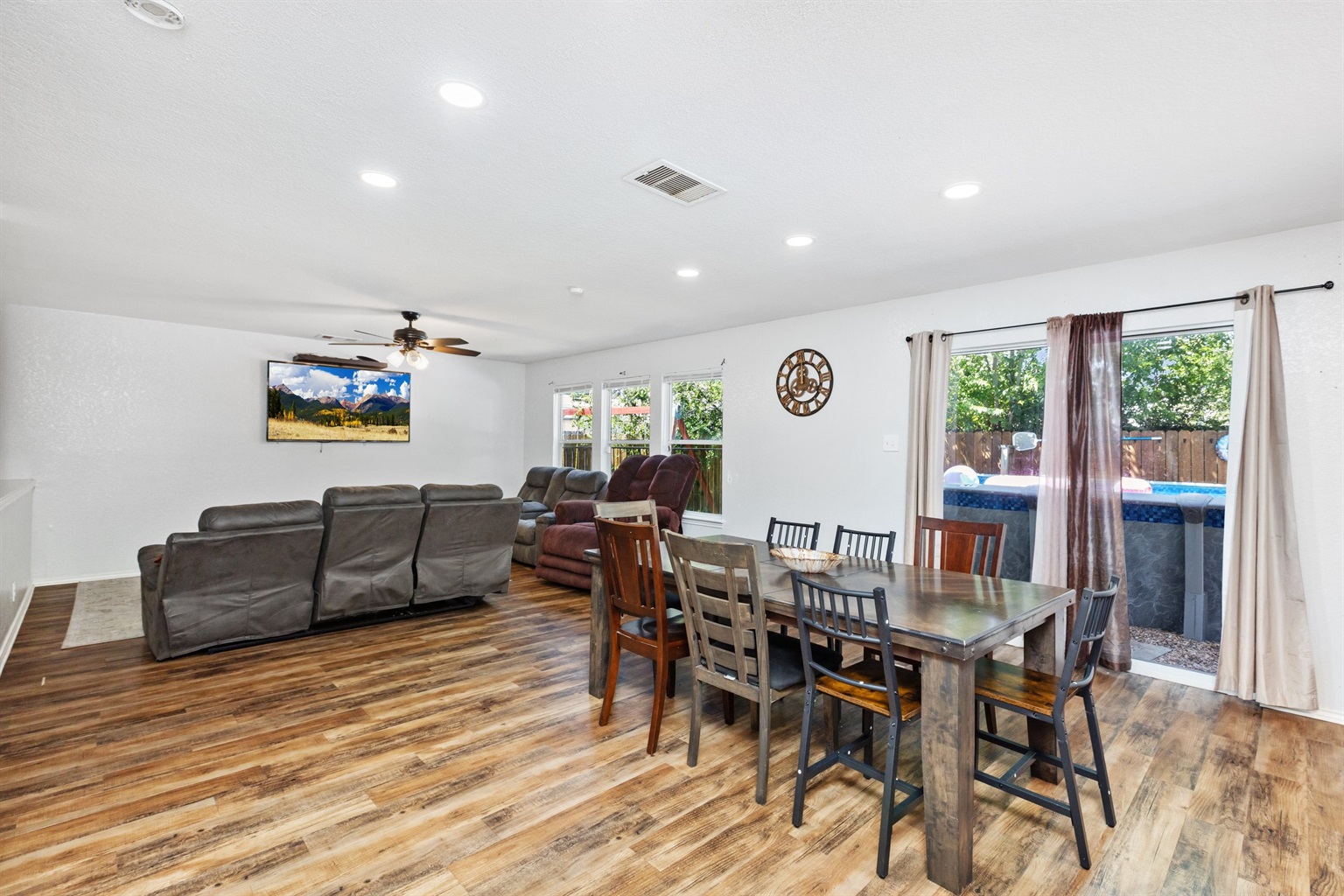 Wide open-concept main floor with hardwood floors, natural light, and connected living, dining, and kitchen spaces. Designed for families and groups who want space to move and gather. San Antonio, TX.
