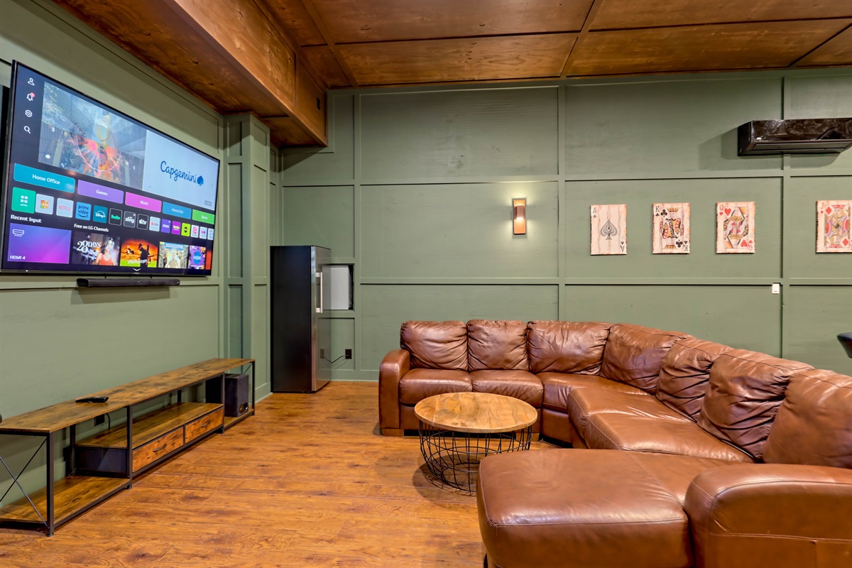 Cozy seating area in the game room with a large smart TV.