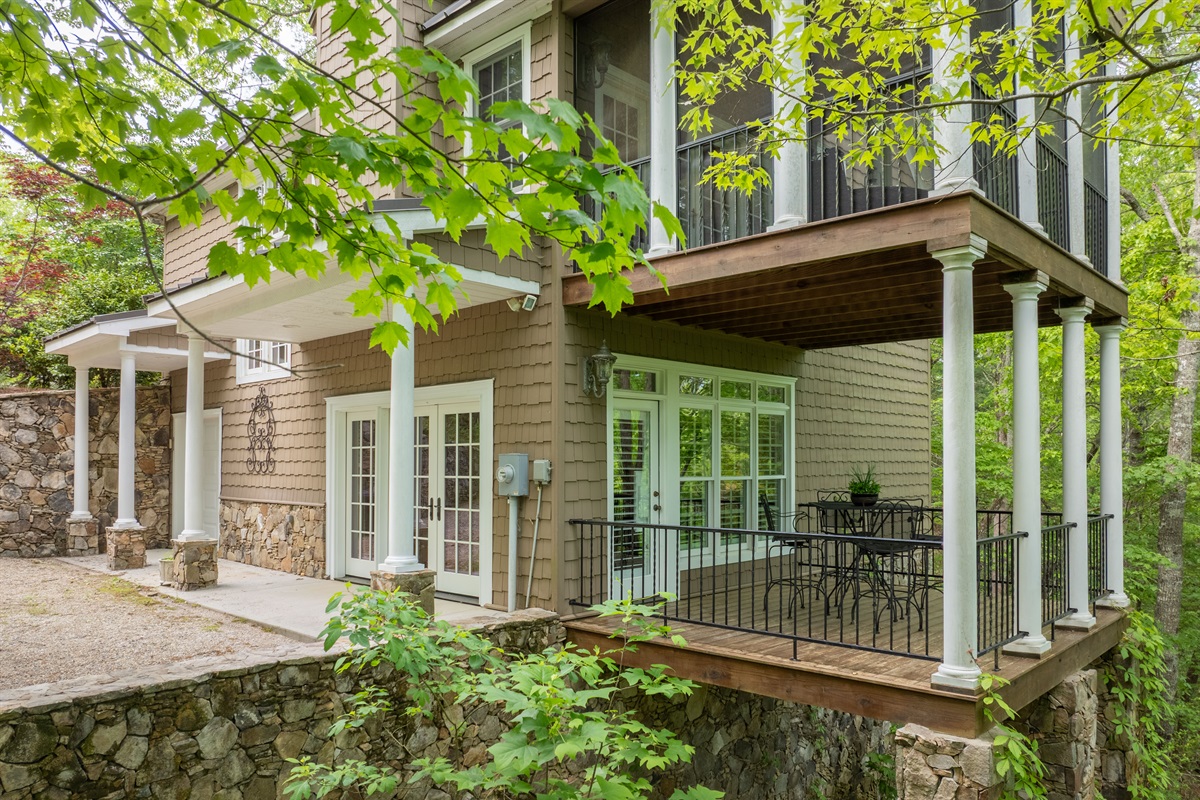 Enjoy peaceful wooded surroundings from the private lower-level covered deck just outside the guest suite.