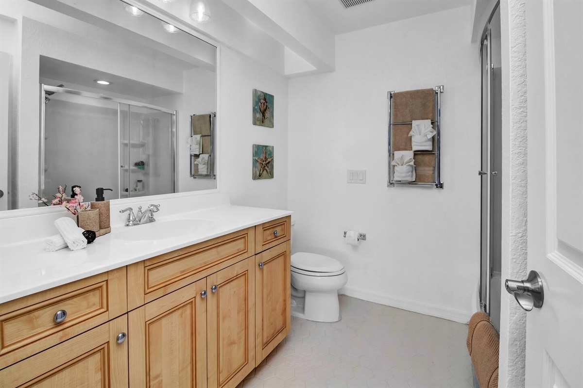 3rd full bath has a 5ft tub with a closet & spacious sink countertop.