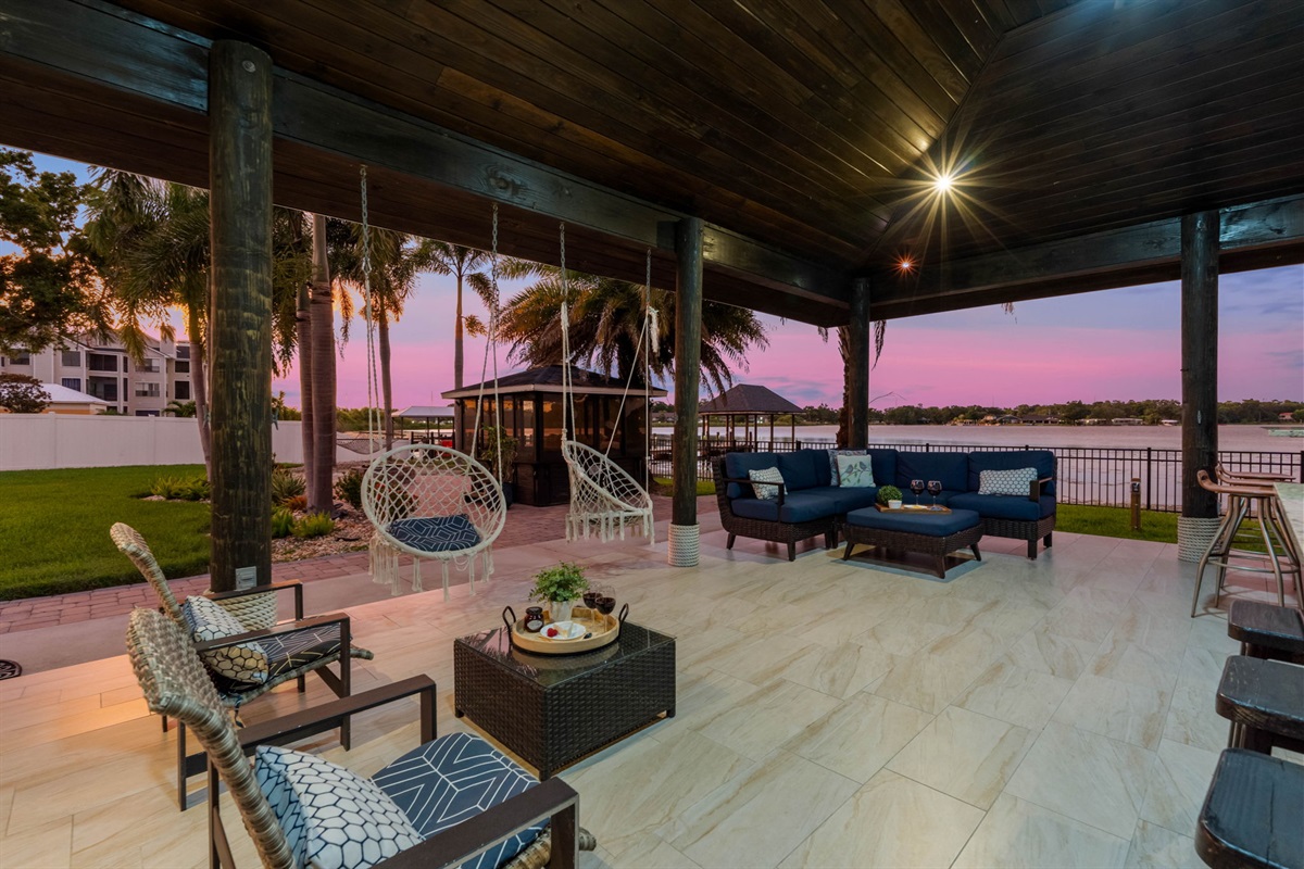Experience the magic of twilight in this waterfront entertainment area, offering a bar, grill, and ample seating in a tropical setting.