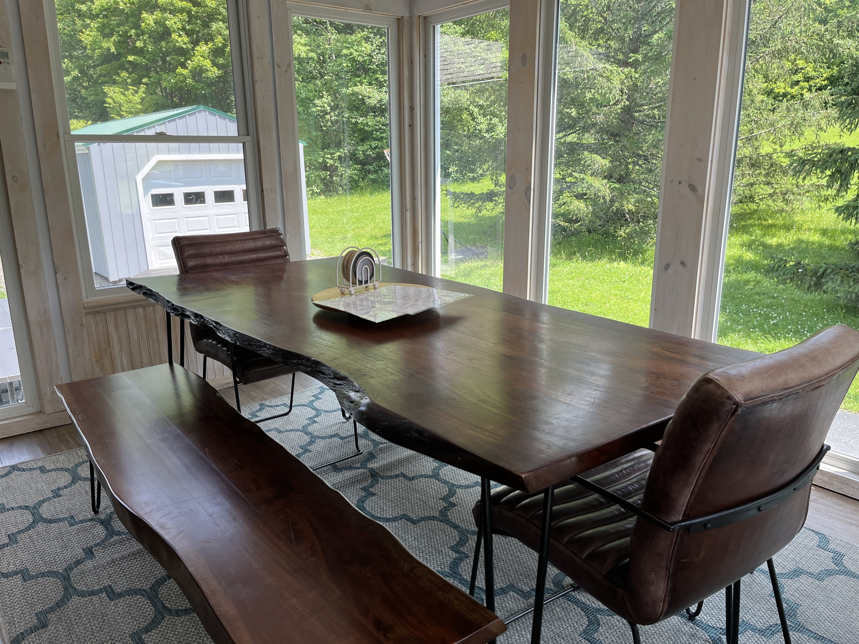 Dining room feels like it is outside will all the windows surrounding it. Notice the garage game room beyond.