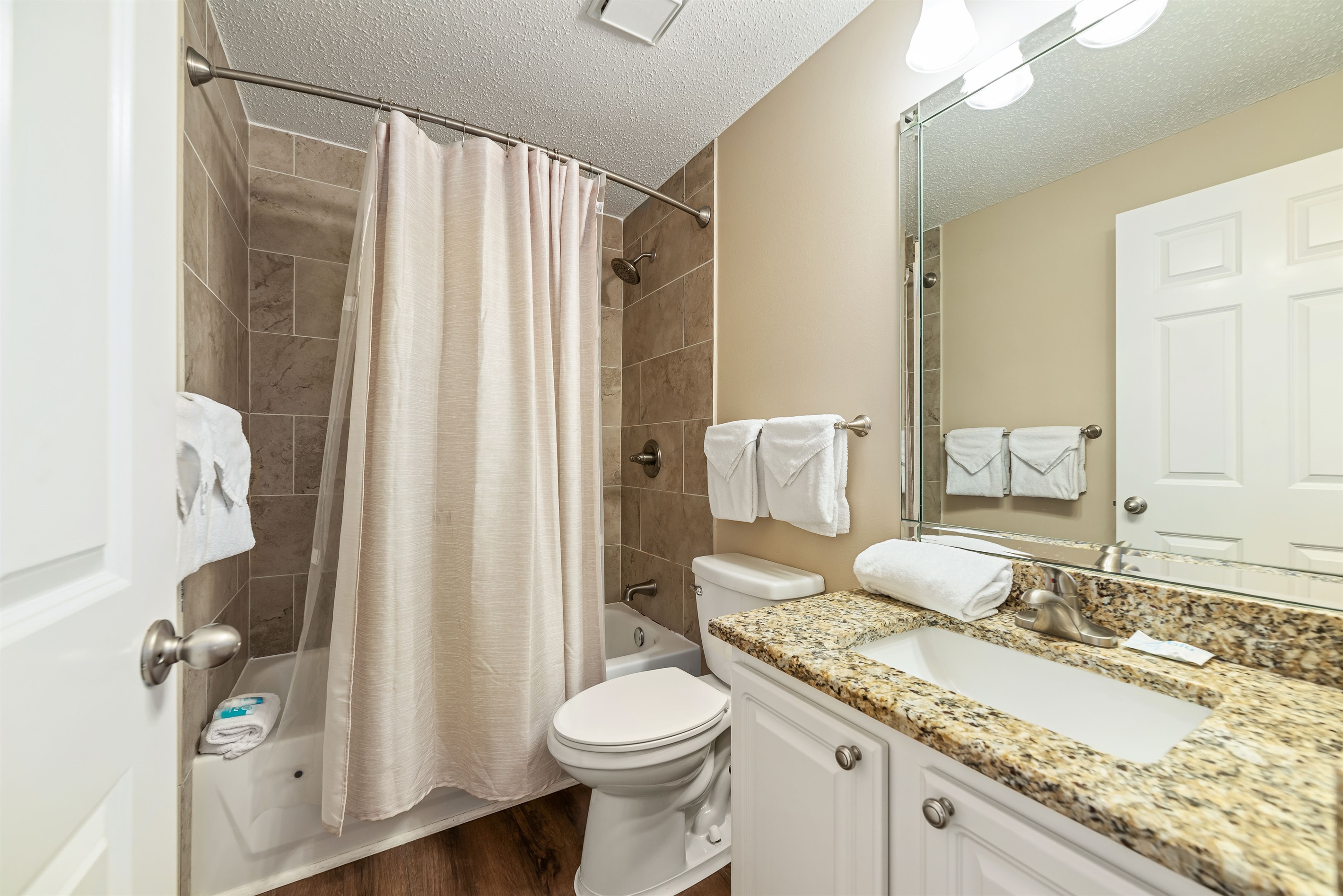 Freshly updated bathroom featuring a shower/tub combination, ample vanity space, and modern fixtures.