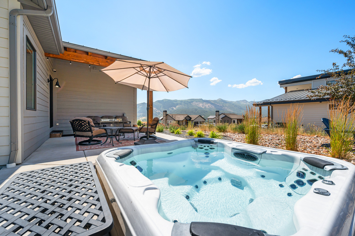 Soak under the open Utah sky in your private hot tub while taking in the peaceful mountain surroundings.