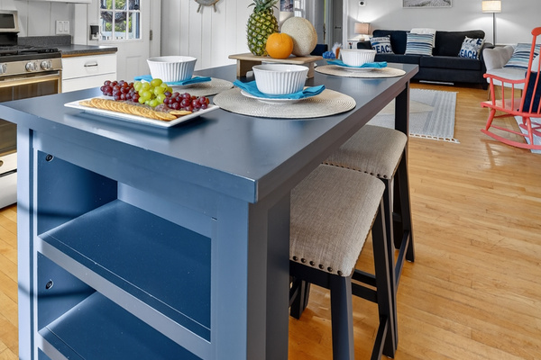 Large kitchen island with additional seating and open shelving—perfect for casual meals, morning coffee, or entertaining.