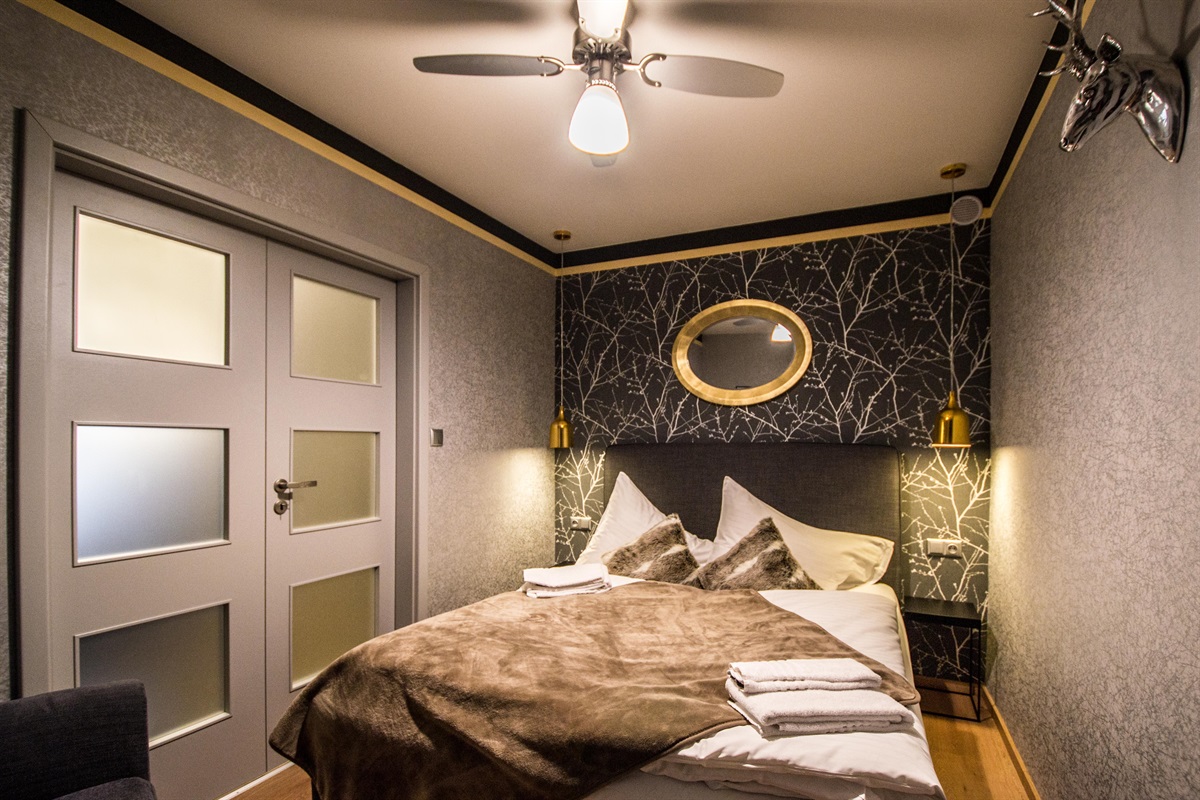 1st bedroom with a big comfy bed. There is also a fan on the ceiling, so it won't be hot during summer days!