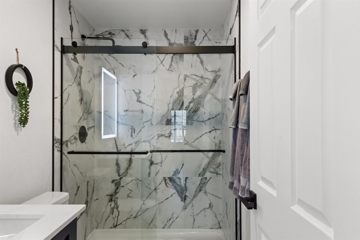Refresh and recharge in the clean and relaxing bathroom with a walk in shower