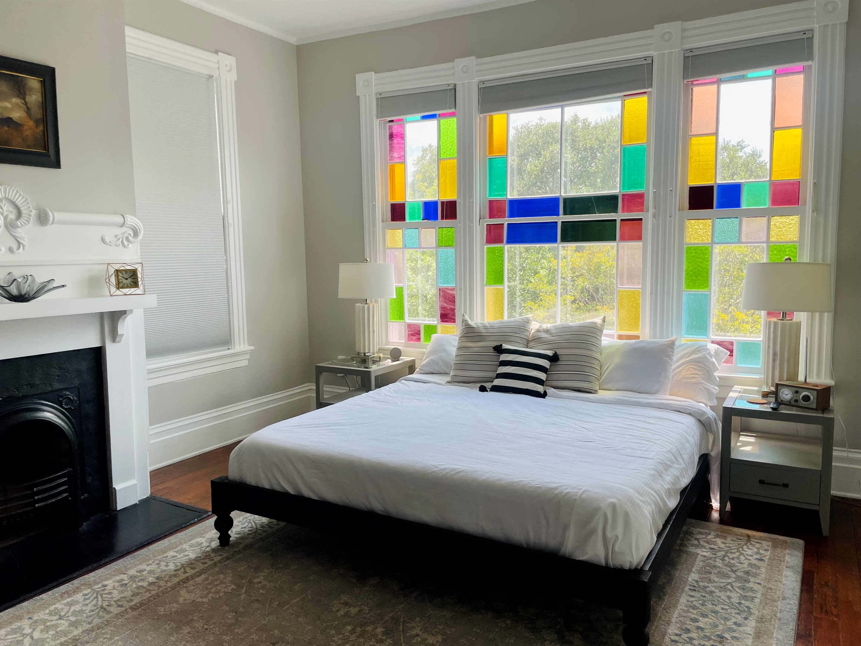 Primary bedroom with ensuite bath is truly a gem.  Stretch out on the king sized bed, enjoying the Savannah sunshine shining through the stain glass windows.  Located on one of the quieter blo