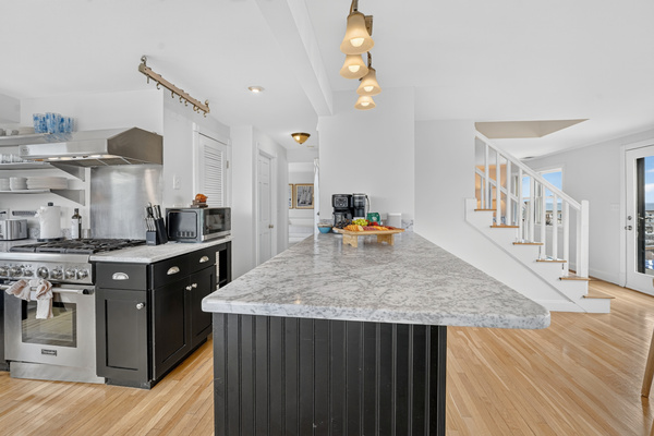 Spacious kitchen island provides plenty of room for preparing meals and gathering together.