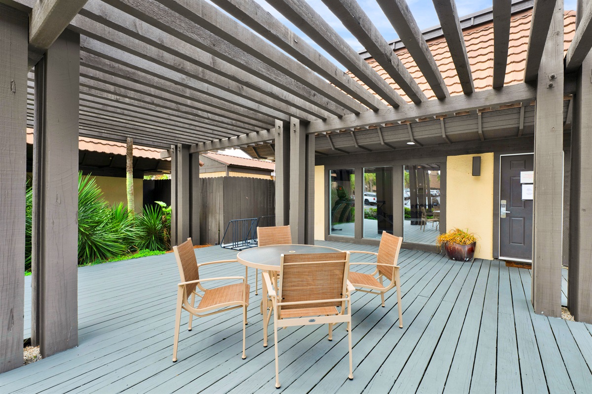 Table and chairs in pool cabana area 